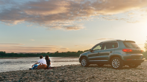 Family parked next to beach, enjoying the sun