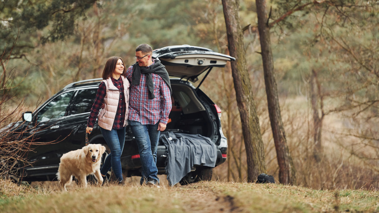 Family going for a walk with their dog in the countryside