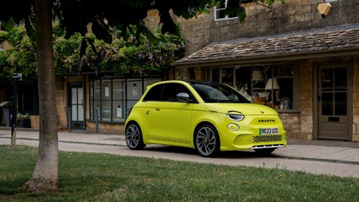 Yellow Abarth Driving On Road Front