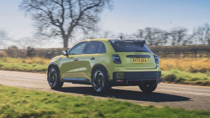 Green Abarth driving in the countryside