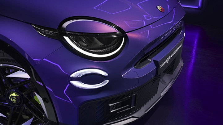 Headlights of a purple Abarth 600e