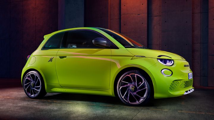 Yellow Abarth 500e parked on a black wall background