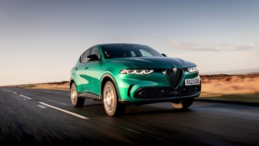 Green Alfa Romeo Tonale driving front left