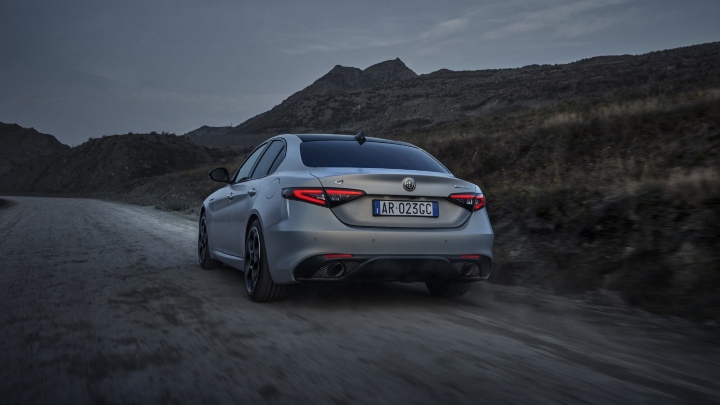 Silver Alfa Romeo Giulia driving rear angle