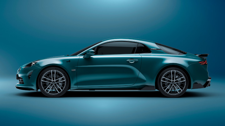 Blue Alpine A110 parked in front of a blue background