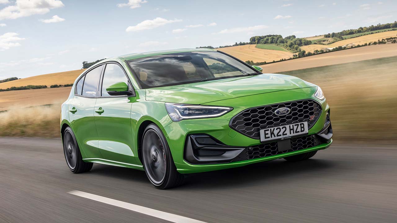 Green Ford Focus Front Driving On Road