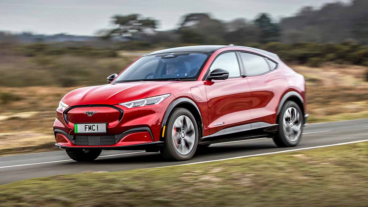 Red Ford Mustang Mach-E Front Driving On Road