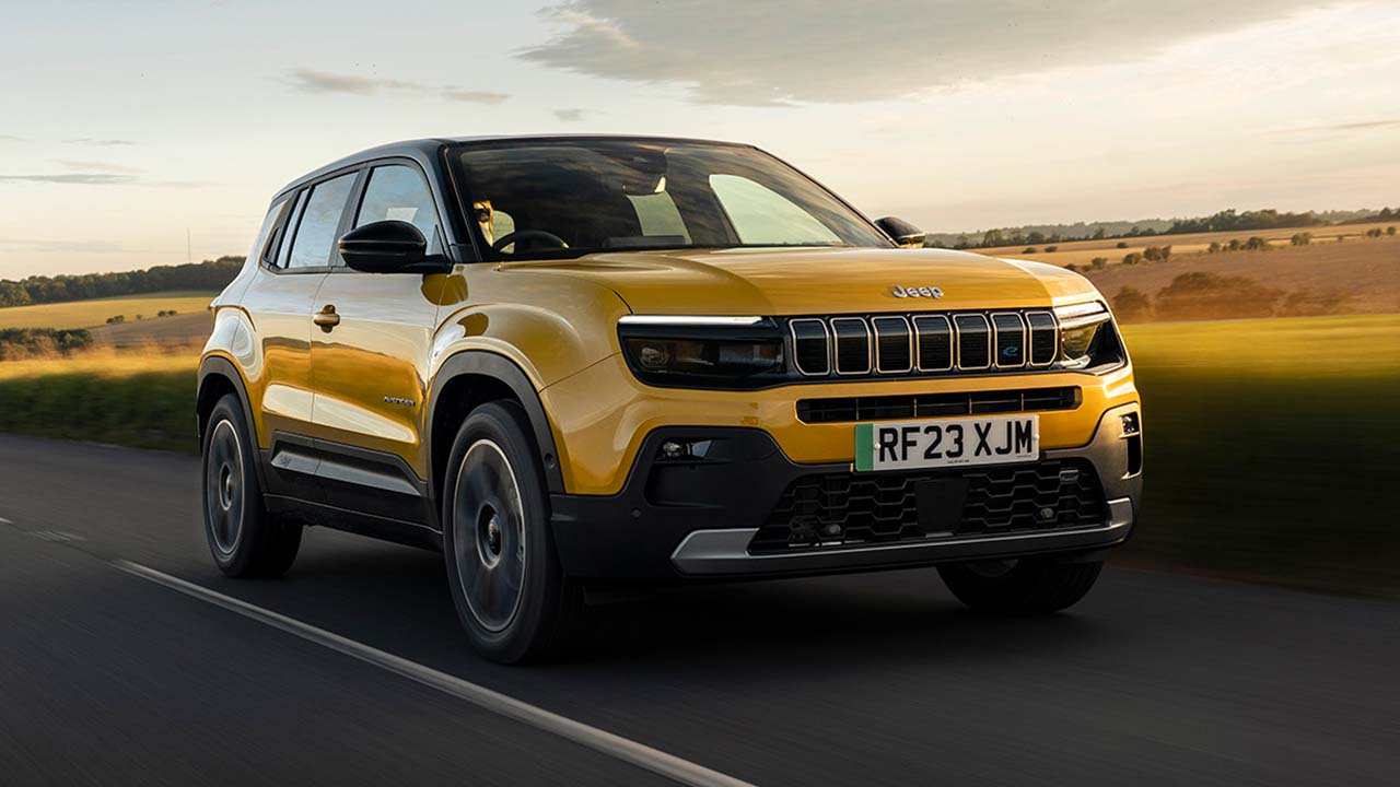Yellow Jeep Avenger Driving On Road