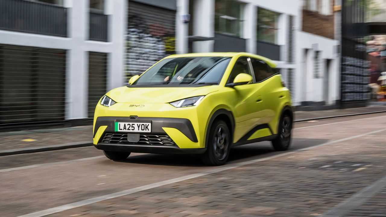 Yellow BYD Dolphin driving on the road