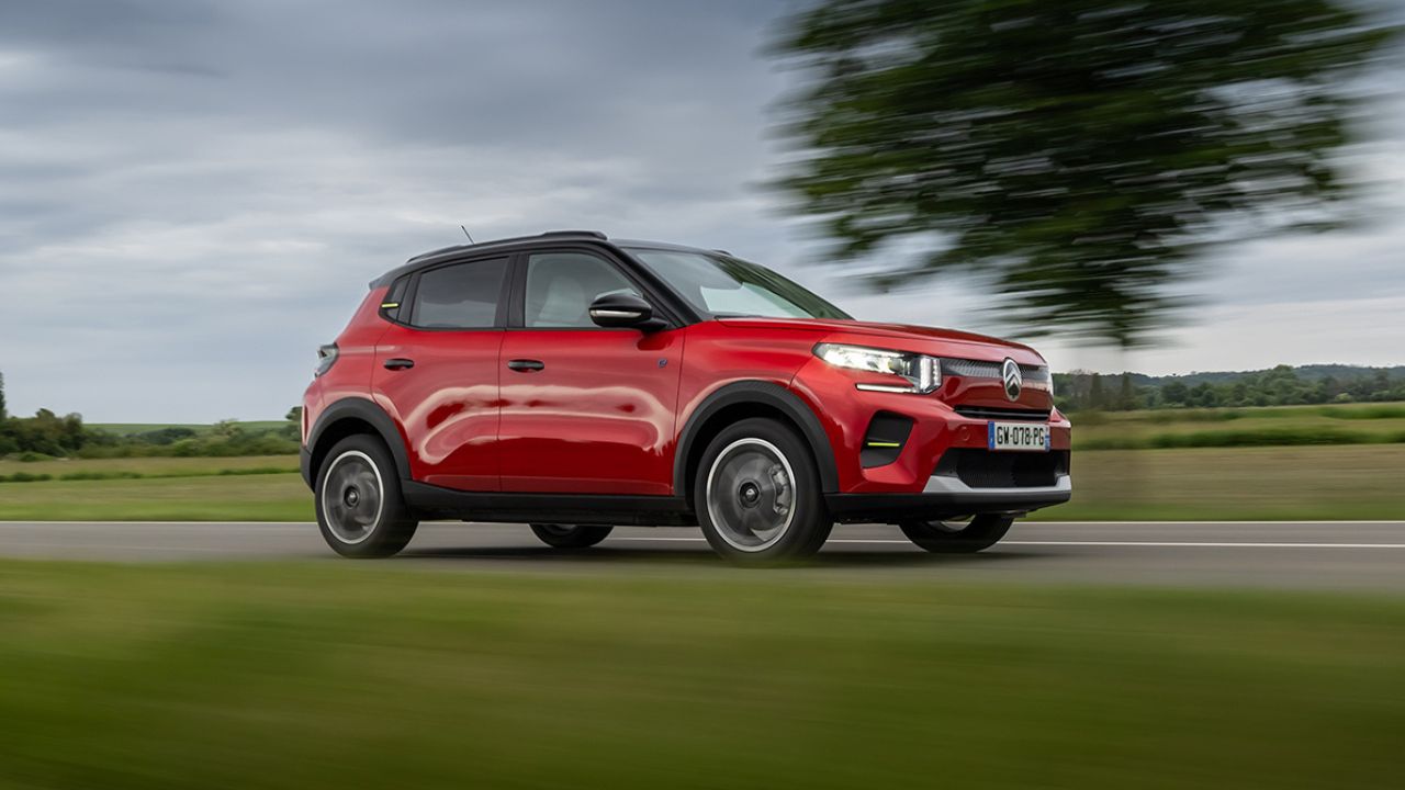 Red Citroen e-C3 driving in the countryside