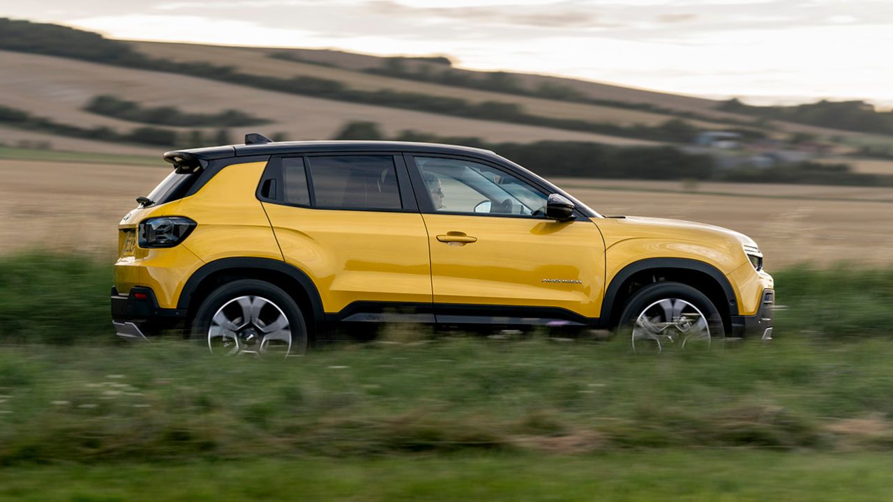 Yellow Jeep Avenger driving in the countryside