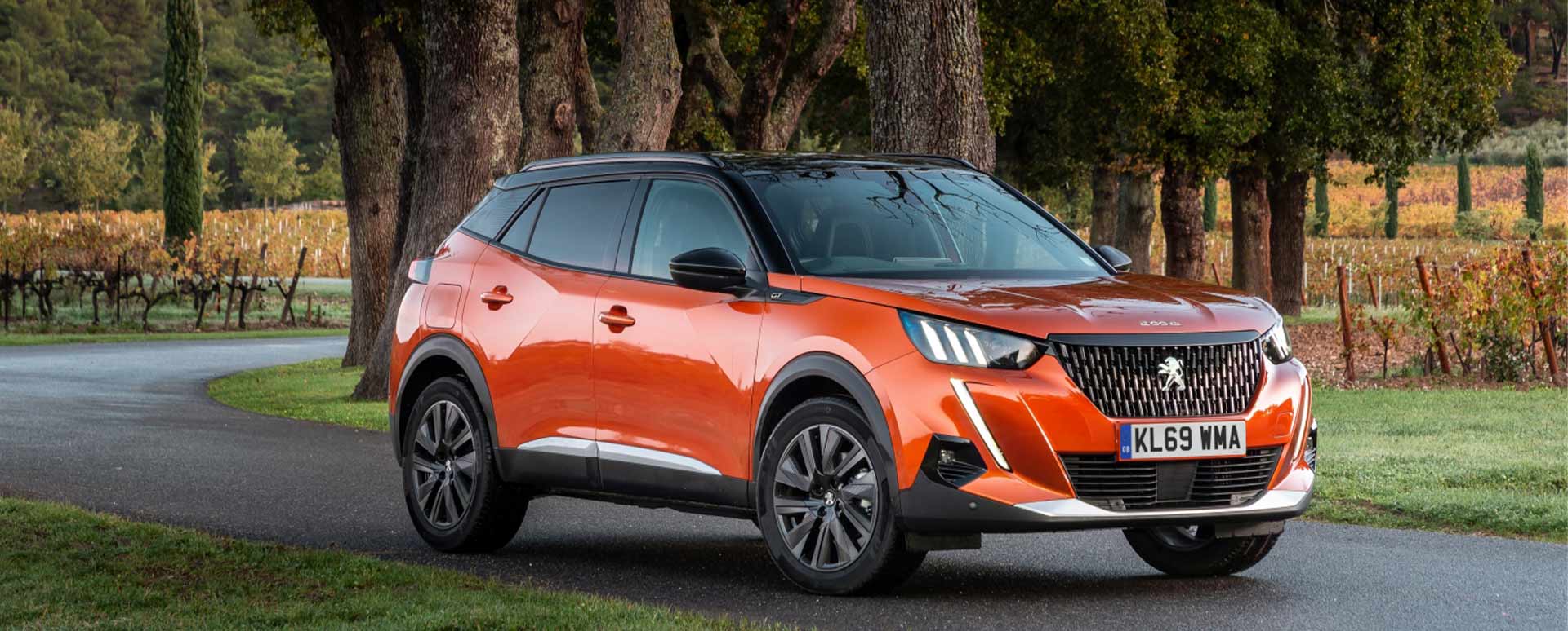 orange peugeot 2008, front, parked