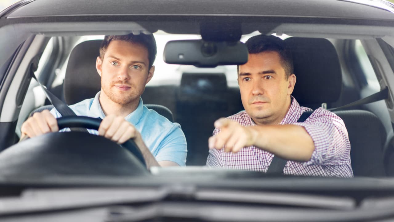 Man Driving Car with Instructor