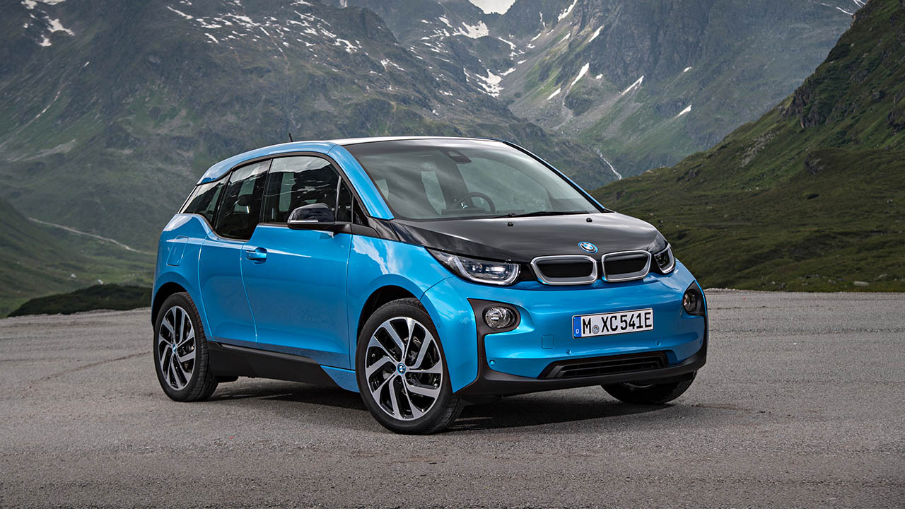 Blue BMW i3, parked with mountain backdrop