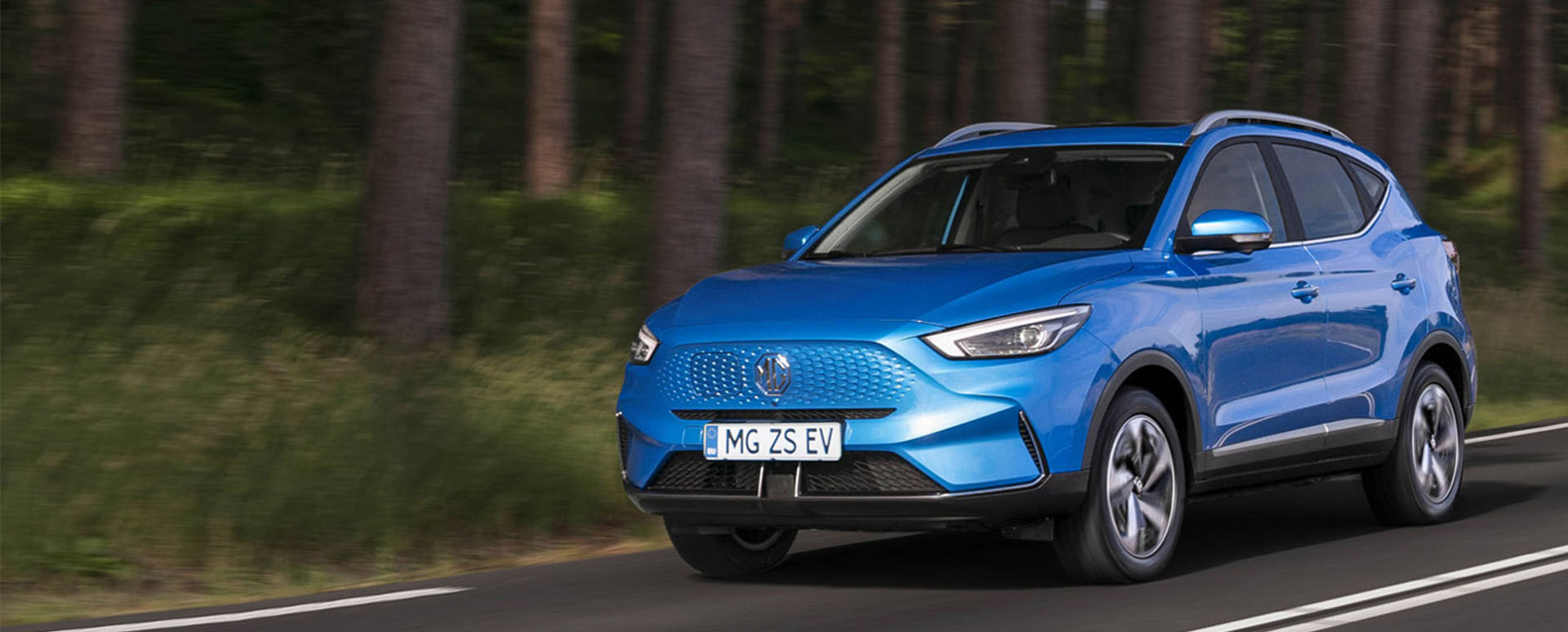 Blue MG ZS EV, driving in countryside