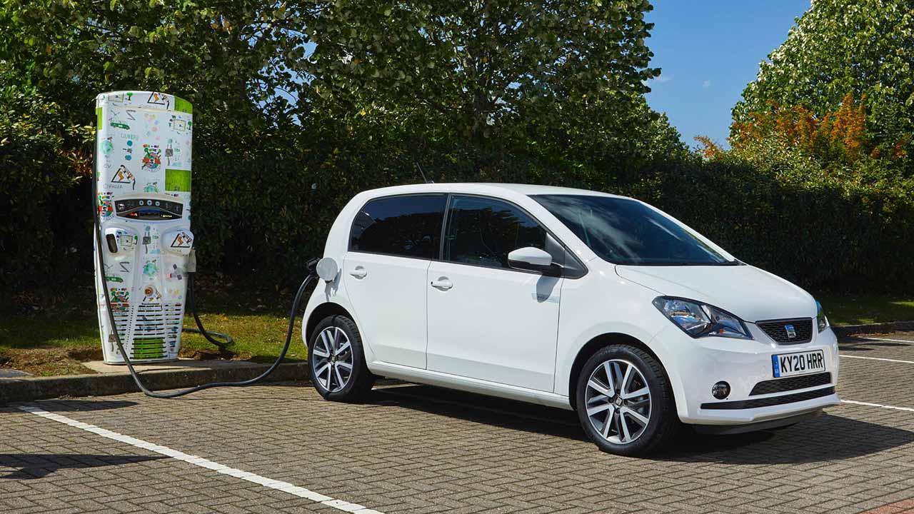 White SEAT Mii Electric, plugged into charging point