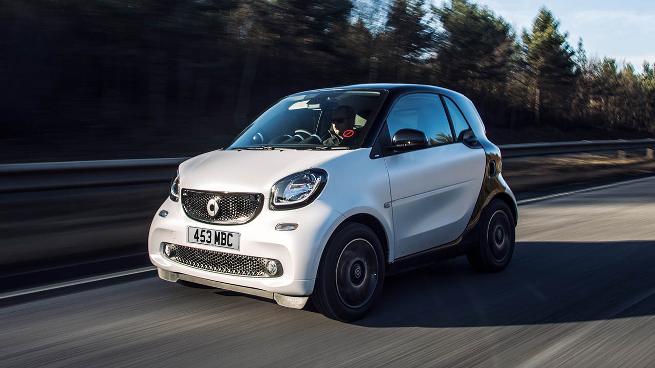 White smart EQ fortwo, driving on open road