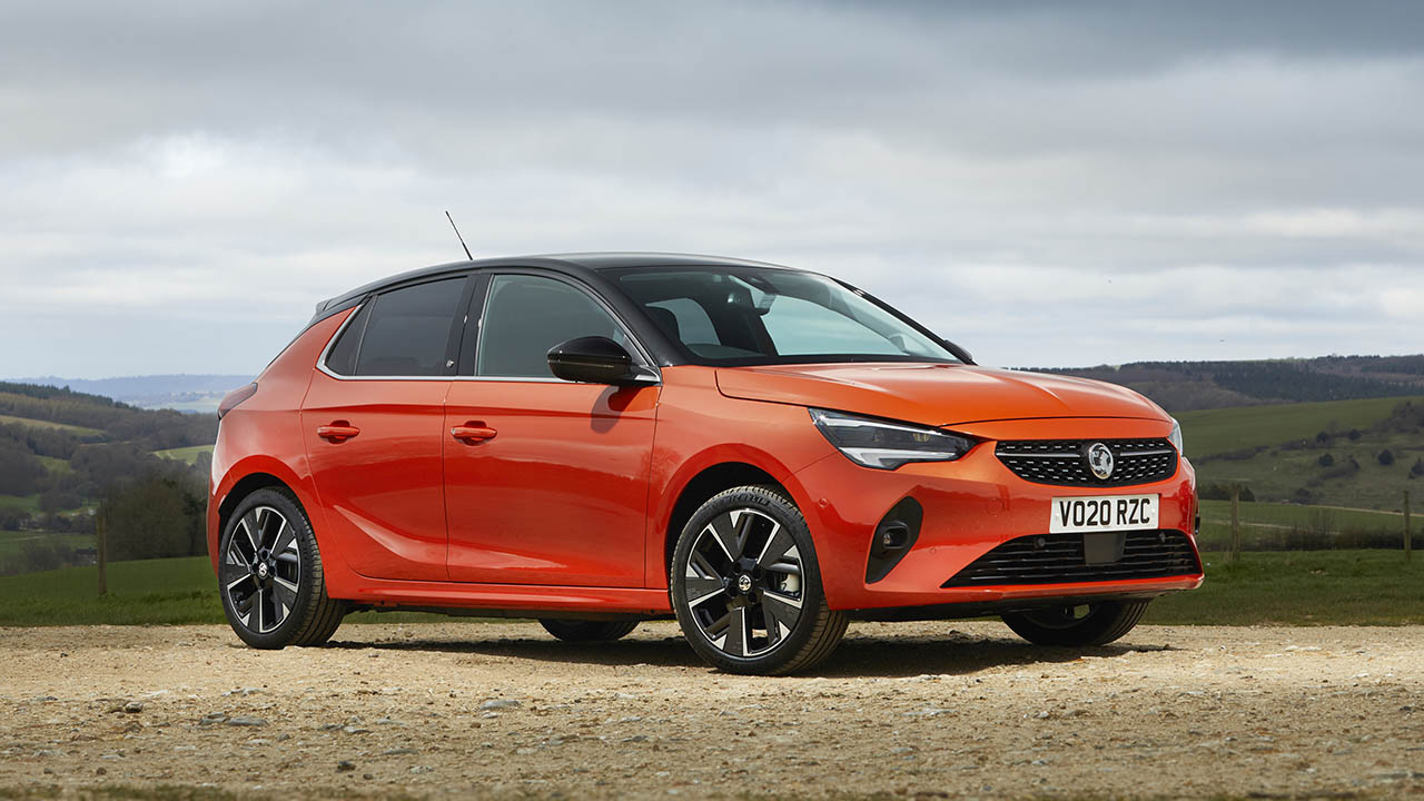 Orange Vauxhall Corsa-e, parked in countryside