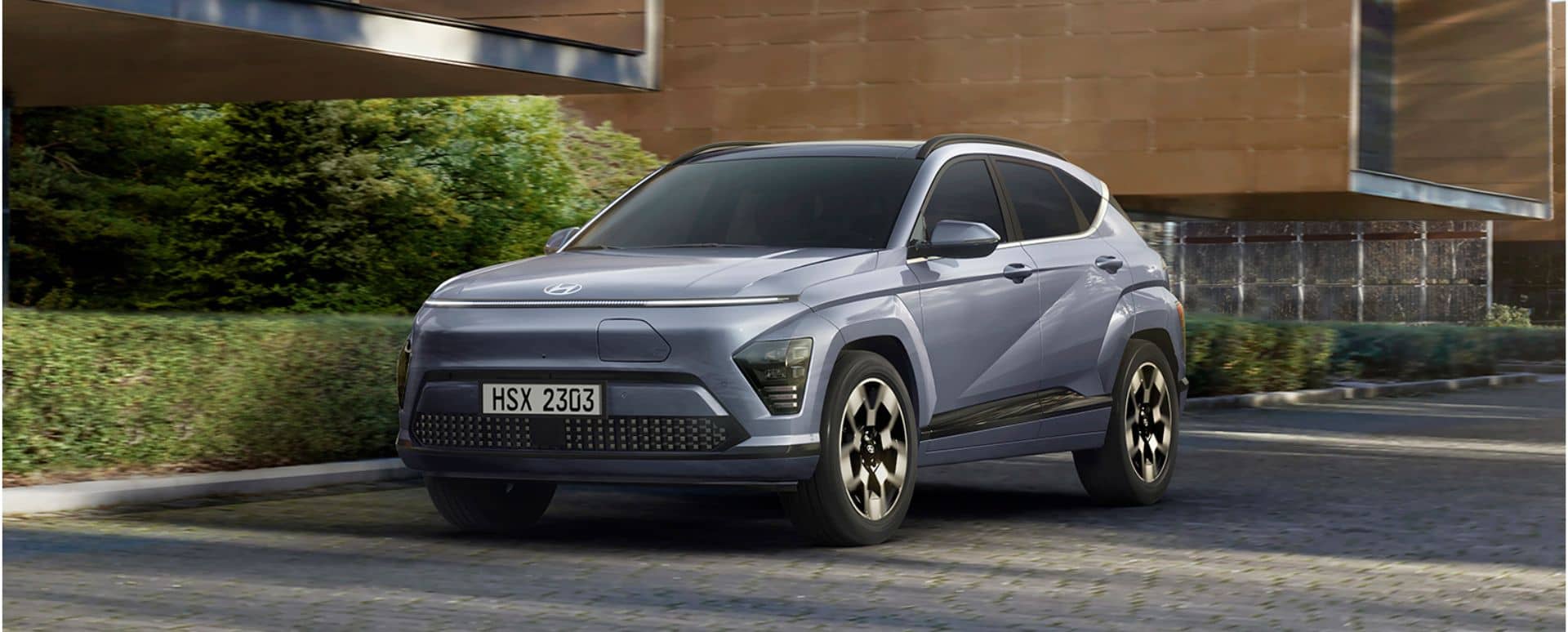 Blue Hyundai Kona parked in front of a modern house