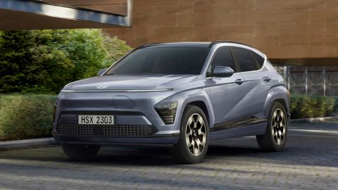 Blue Hyundai Kona parked in front of a modern house