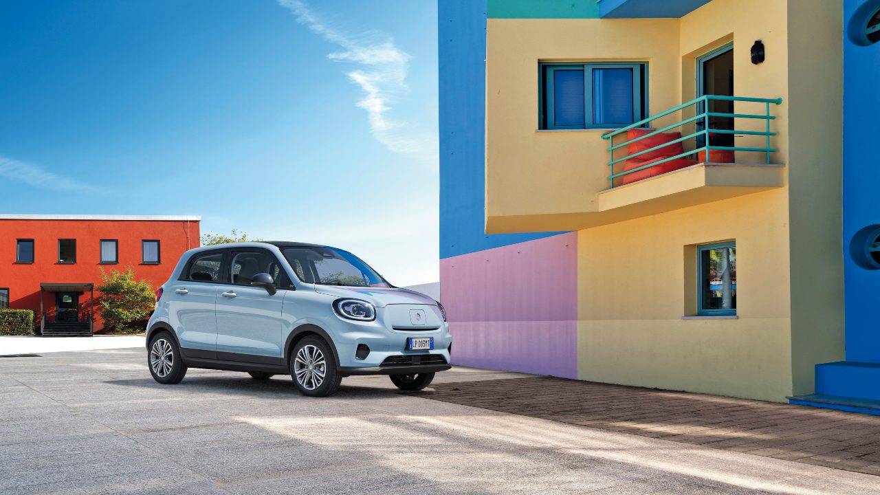 Blue Leapmotor T03 static near colourful houses