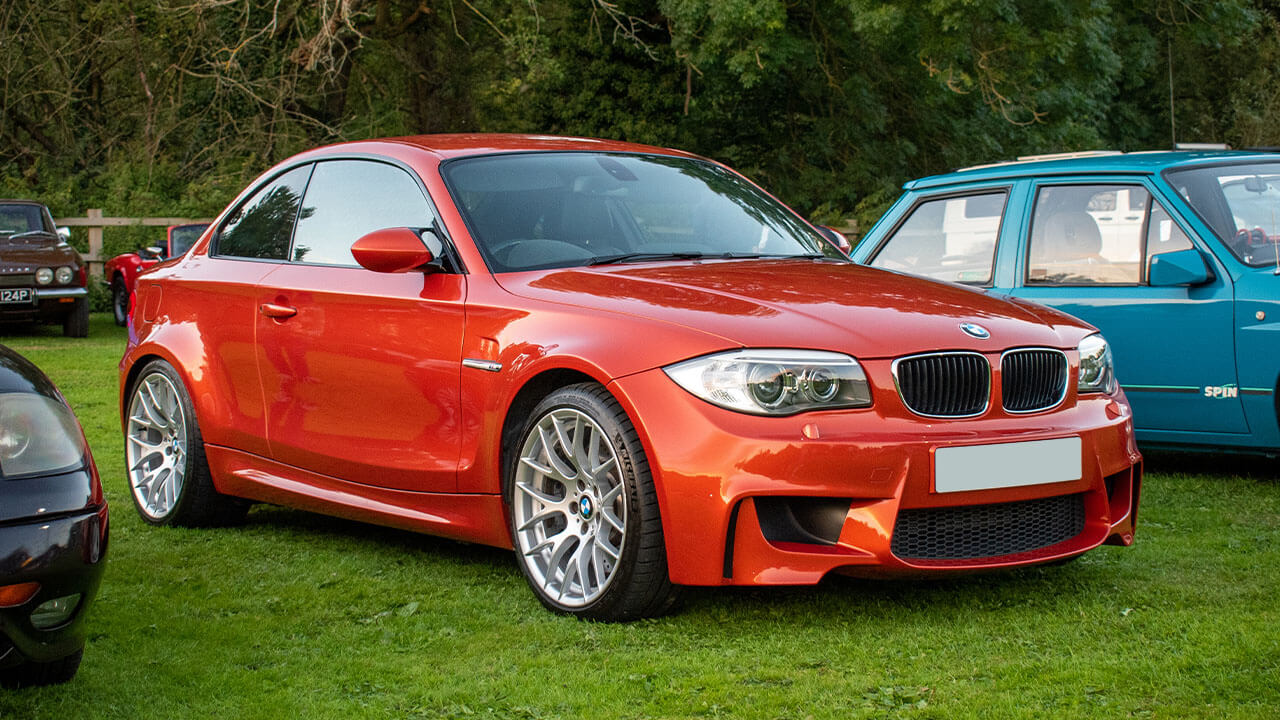 Orange BMW 1M at car show