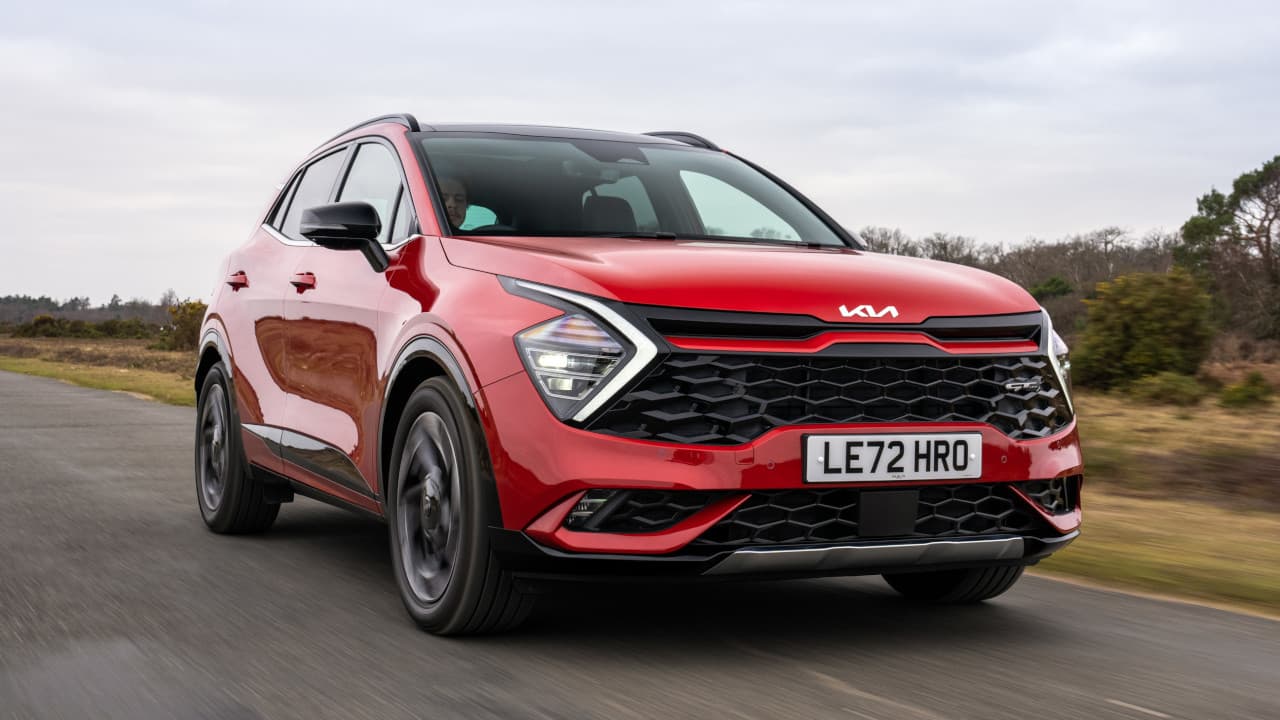 Kia Sportage AWD in Red Driving Front Angle