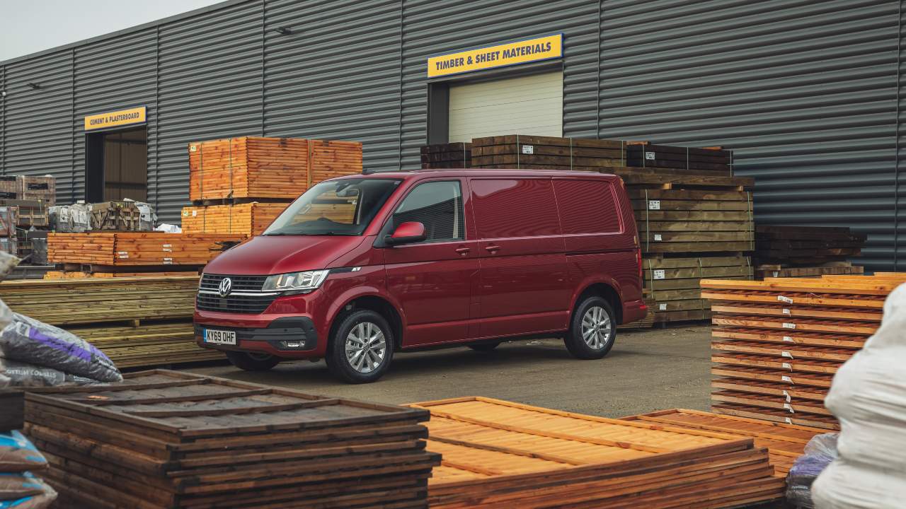 Red Volkswagen transporter in woodyard