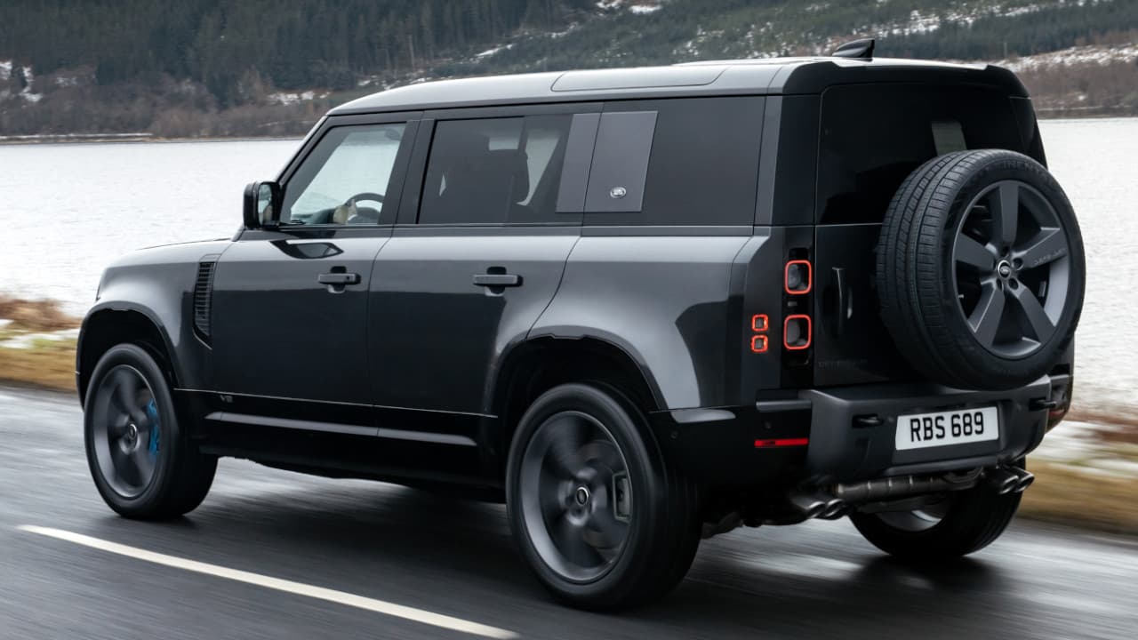 Land Rover Defender 110 V8 Driving in Black Rear Angle