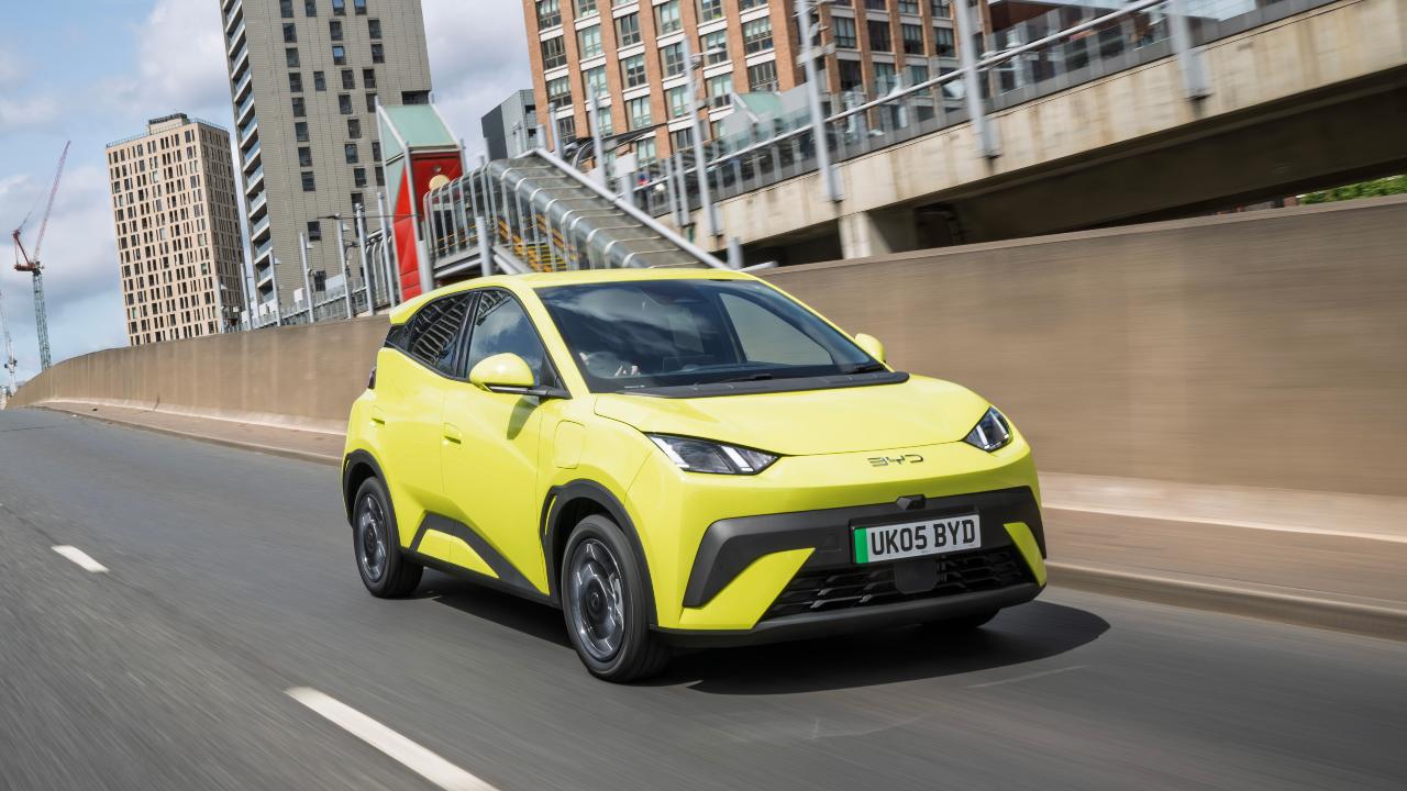 BYD Dolphin surf yellow driving on road