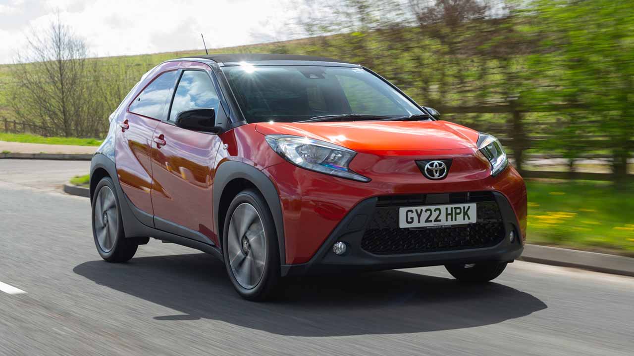 Red Toyota Aygo X Driving