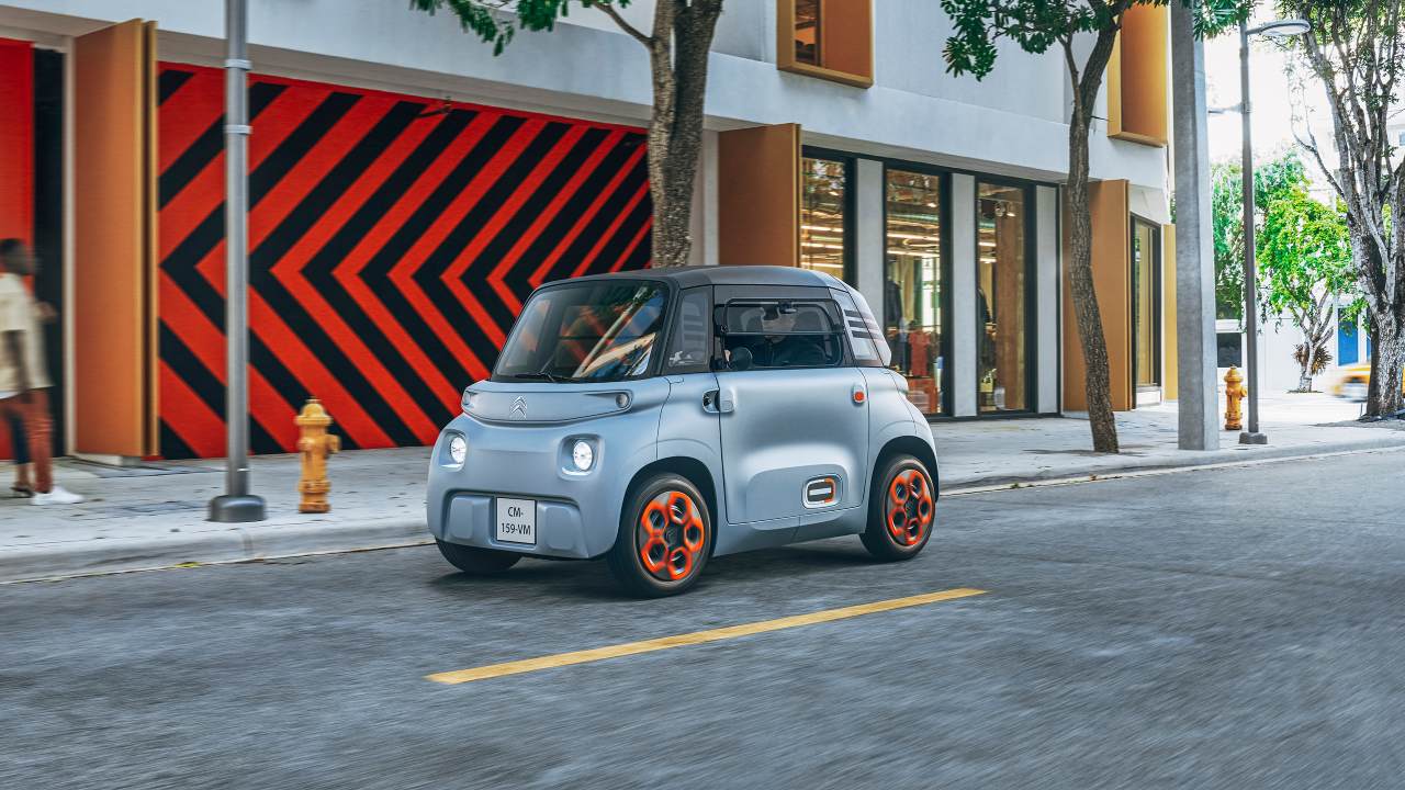 Citroen Ami driving on street front right