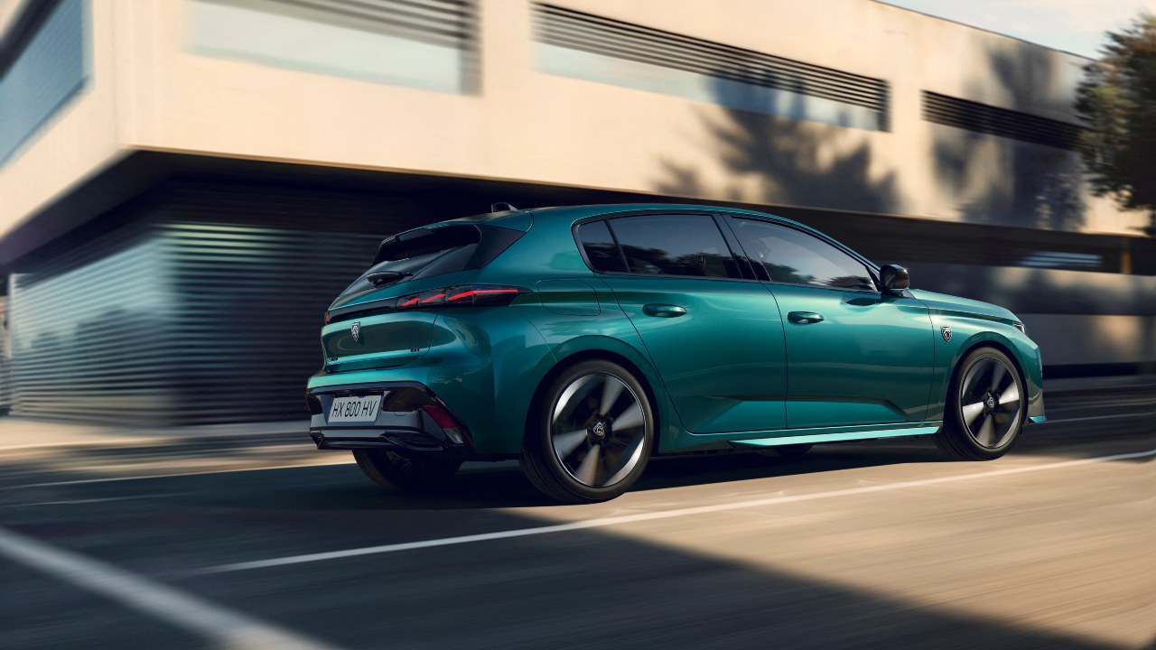 Blue Peugeot 308 driving rear