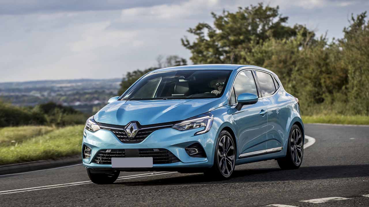 Blue Renault Clio driving in the countryside