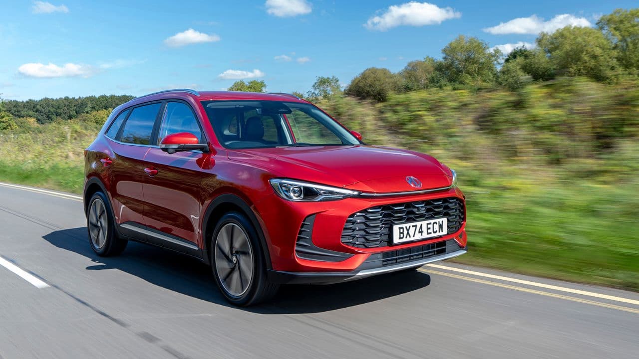 Red MG ZS Hybrid+ driving in the countryside