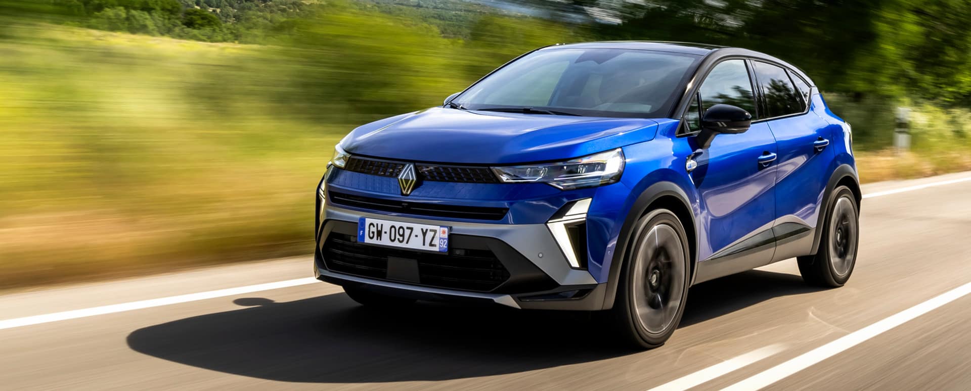 Blue Renault Clio Driving On Road