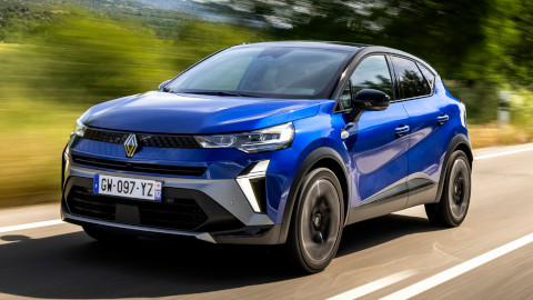 Blue Renault Clio Driving On Road