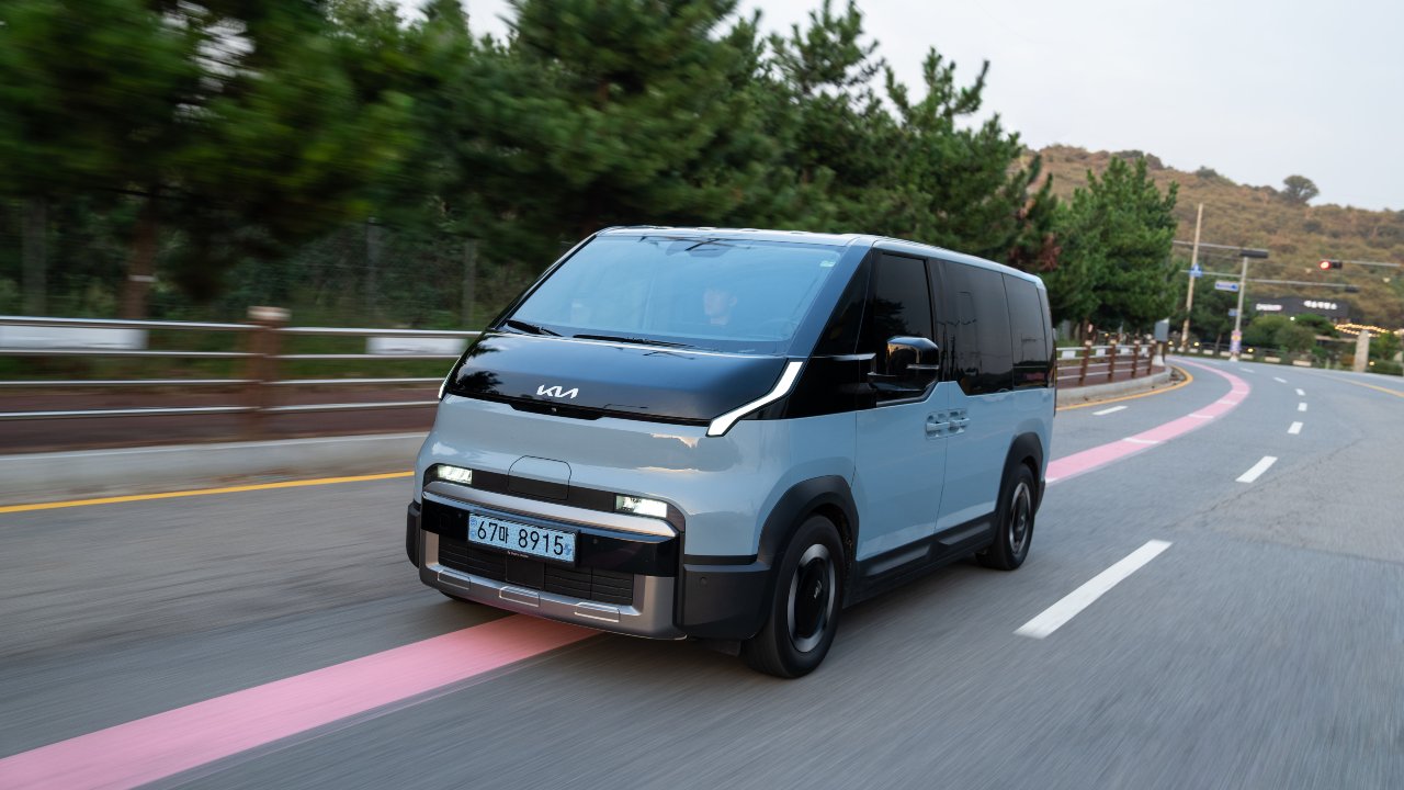 Blue Kia PV5 driving on motorway