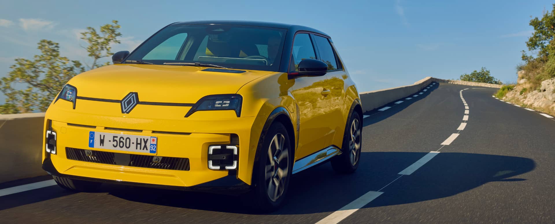 Renault 5 in Yellow Driving on Road