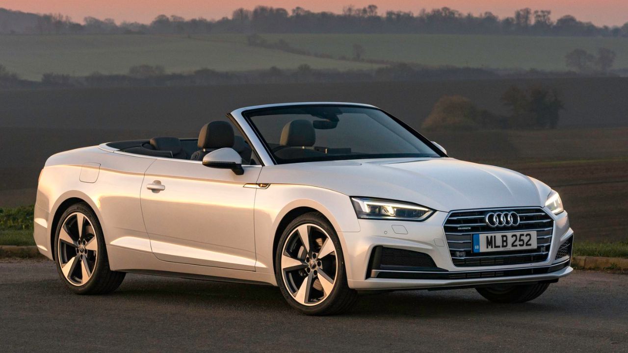 Silver Audi A5 Cabriolet parked in the countryside with mountains in the background