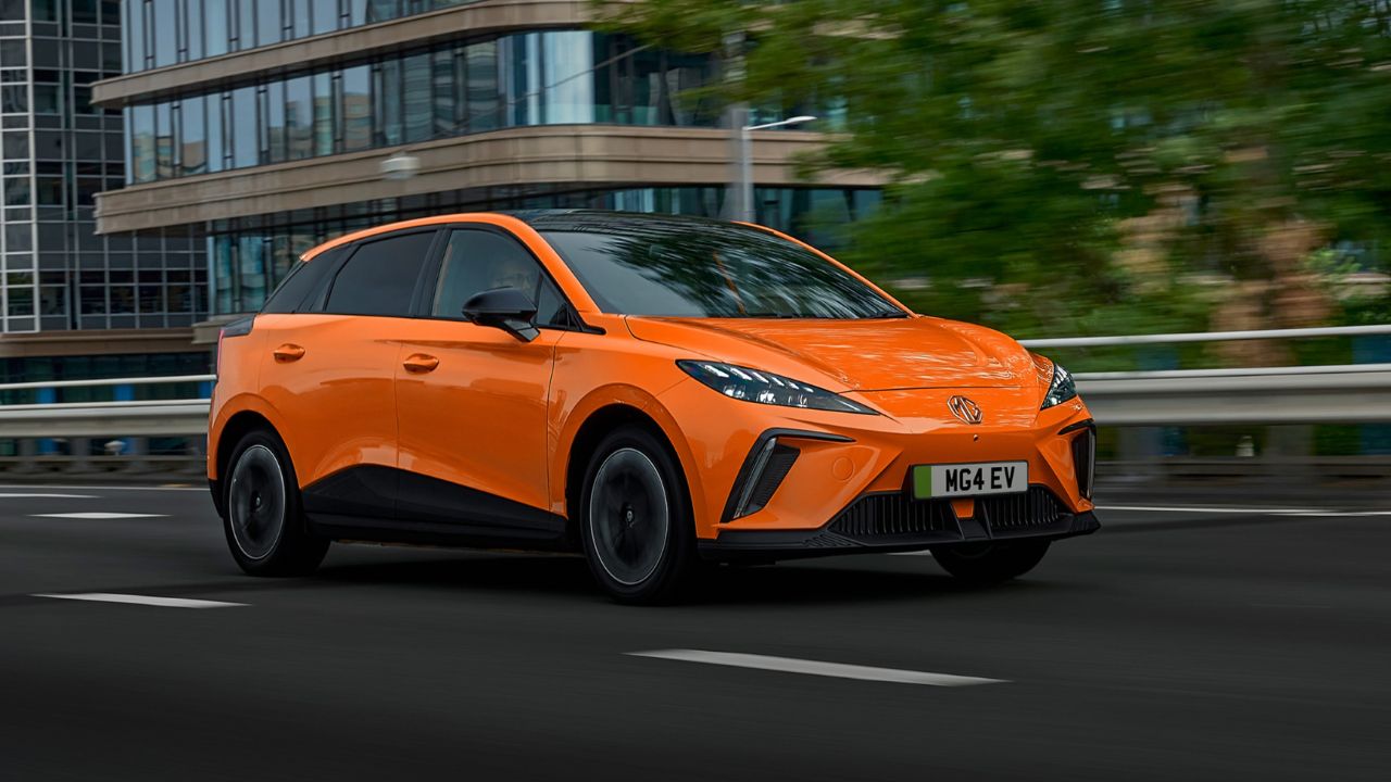 Orange MG4 EV driving on the road