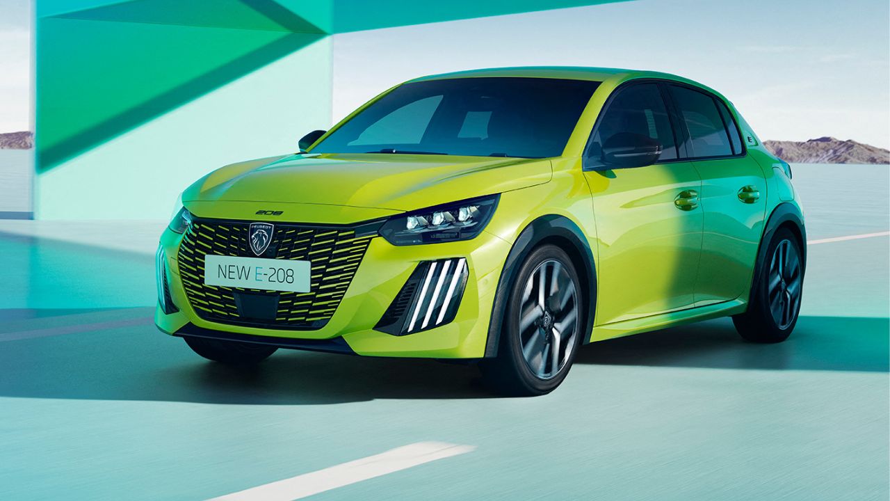 Yellow Peugeot e-208 parked in a green background