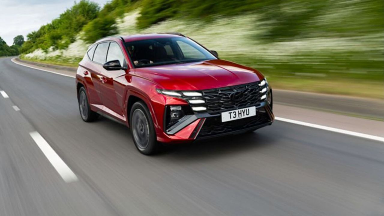 Red Tucson driving on the road