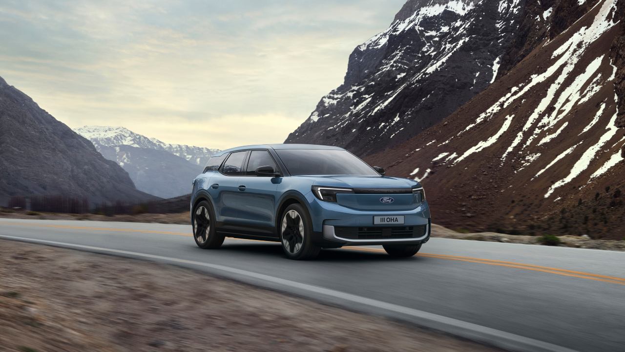 Blue Ford Explorer Exterior Front Driving Mountains