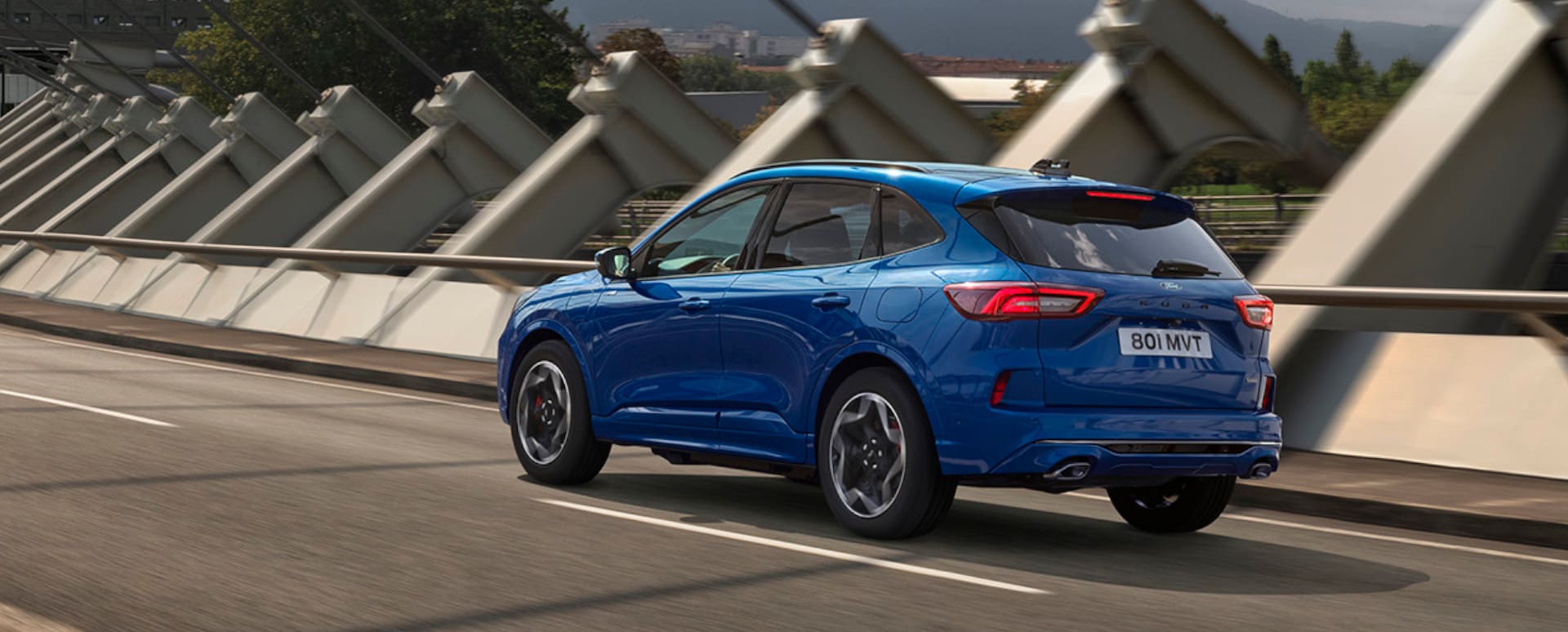 Blue Ford Kuga Rear Driving On Bridge