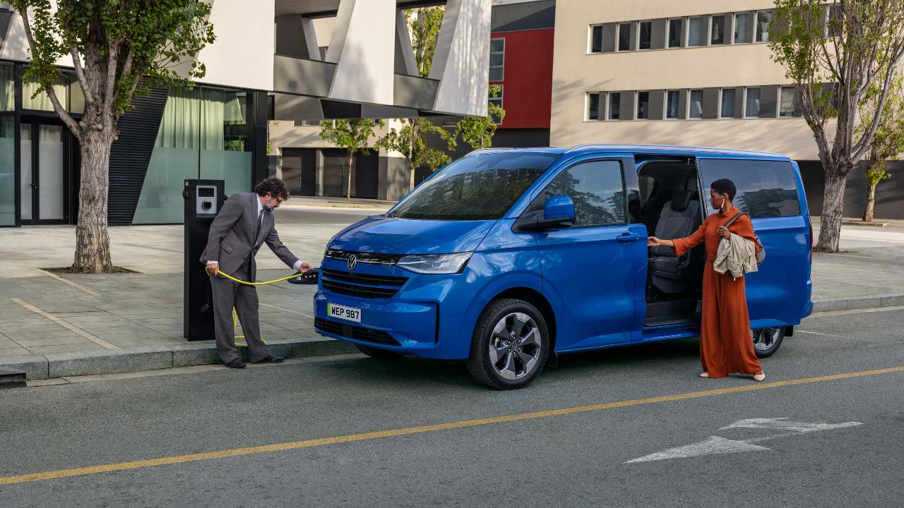 Volkswagen transporter in blue being plugged in