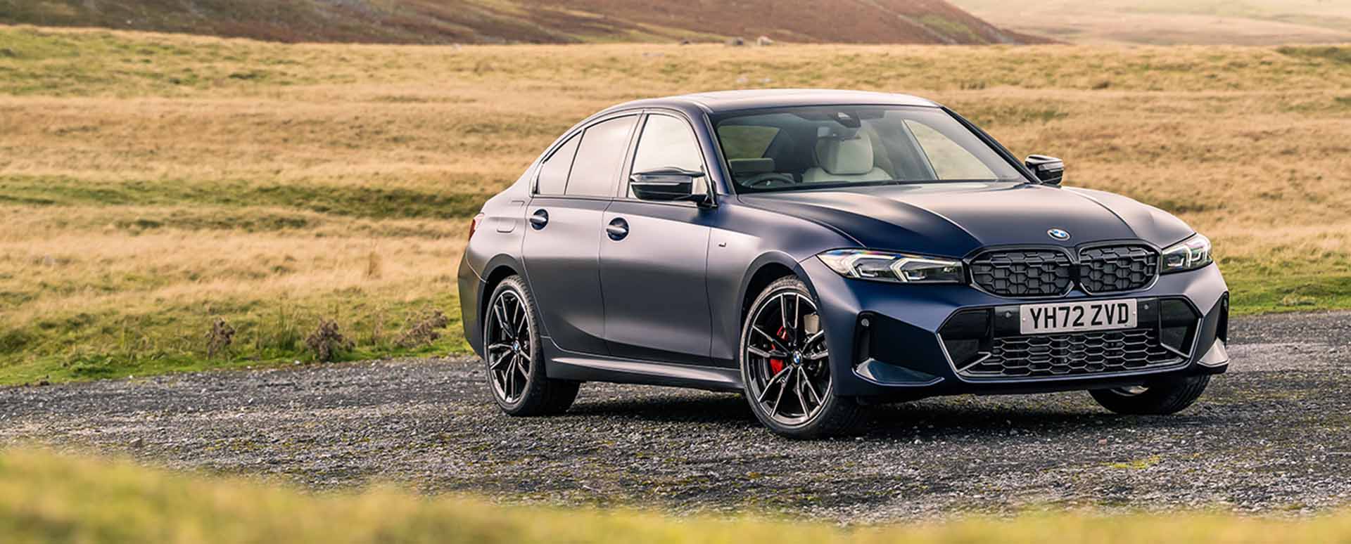 Black BMW 3 Series Parked On Stone Path Surrounded By Grass
