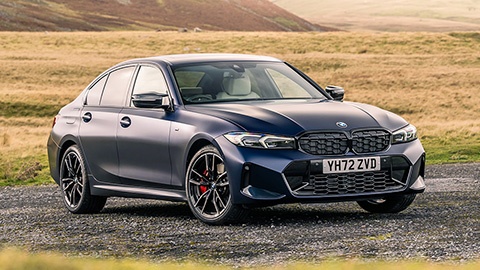 Black BMW 3 Series Parked On Stone Path Surrounded By Grass