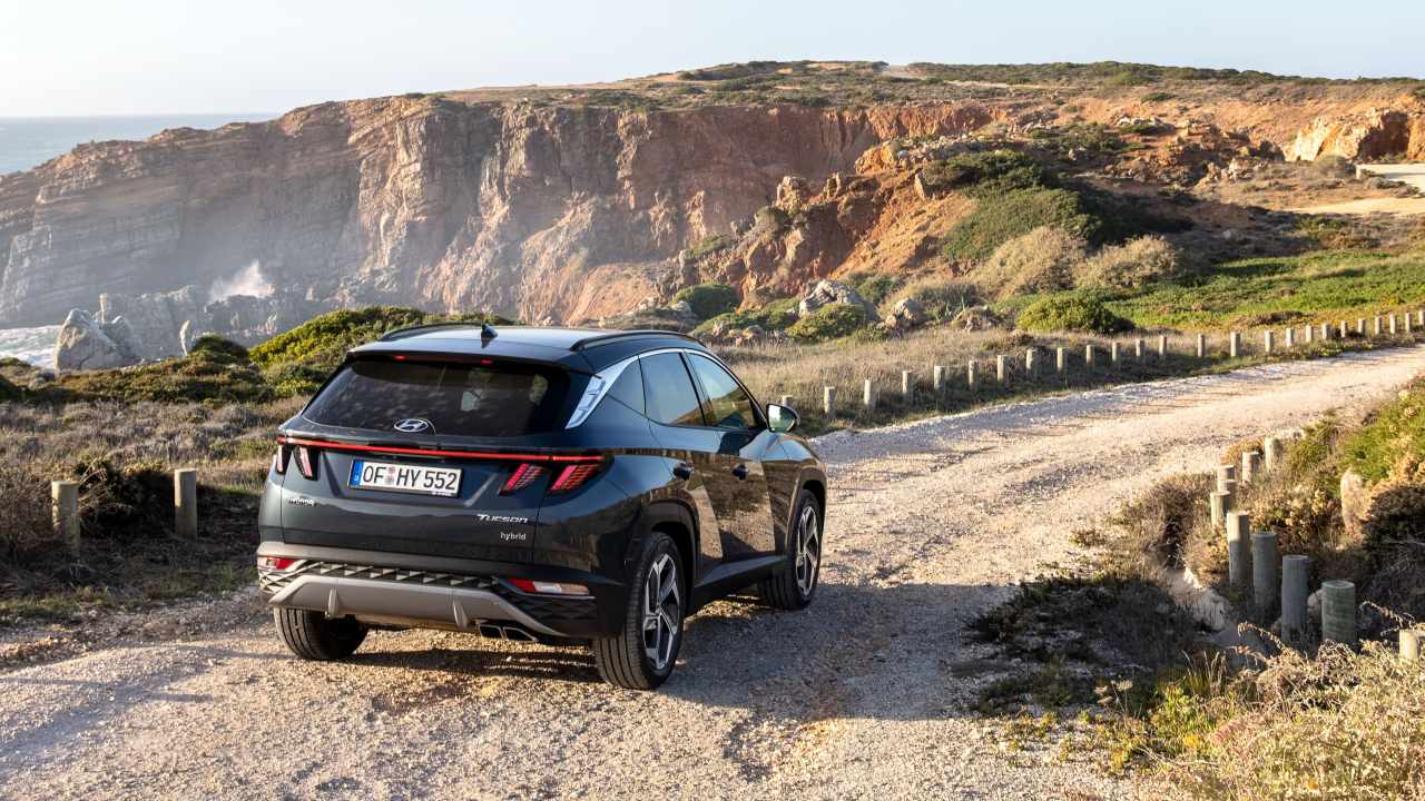 Grey Hyundai Tucson driving on coastal road