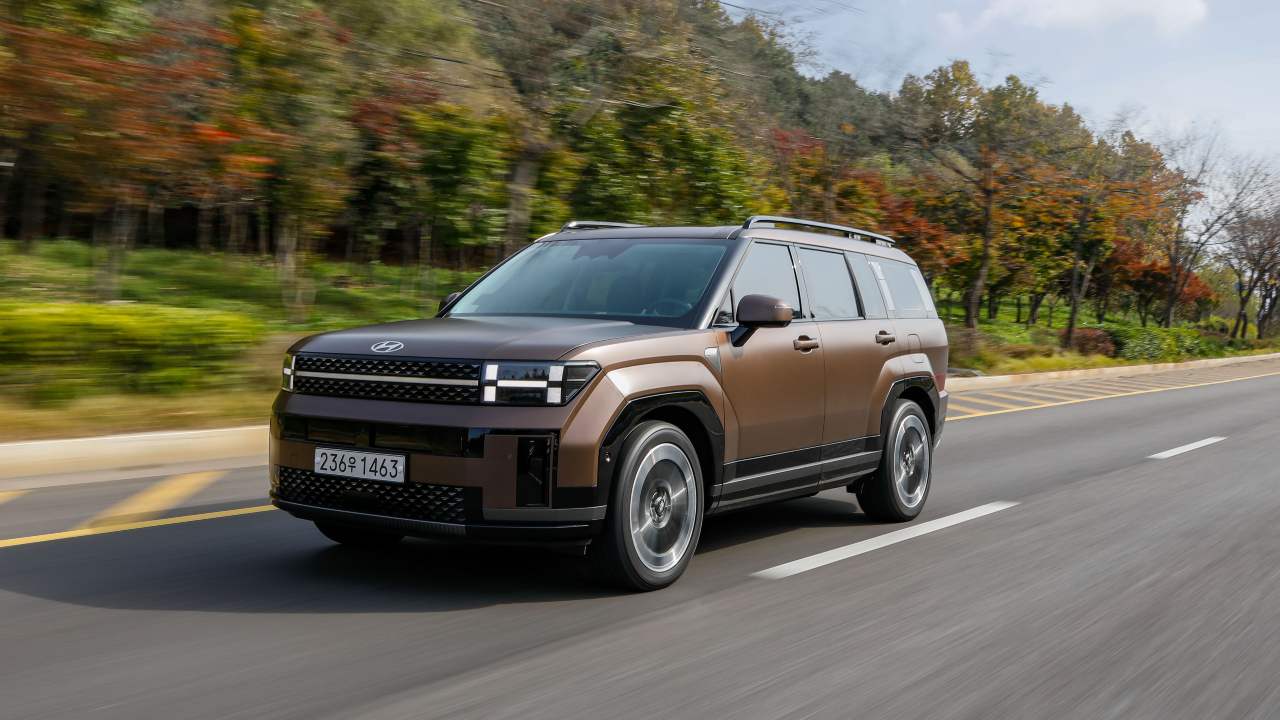 Brown Hyundai Santa Fe driving front right